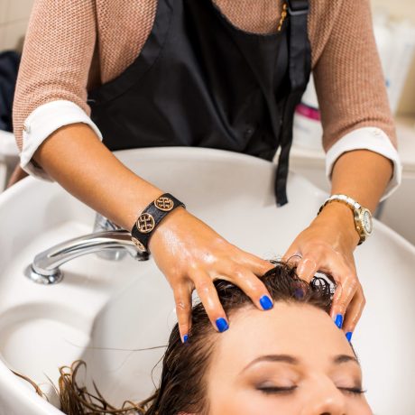 Hairdresser salon. Woman during hair wash