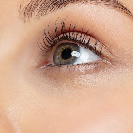 Close up shot of young woman on yellow studio background. Beautiful female model with well-kept skin. Concept of human emotions, facial expression, beauty, healthy lifestyle. Deep eyes looking up.